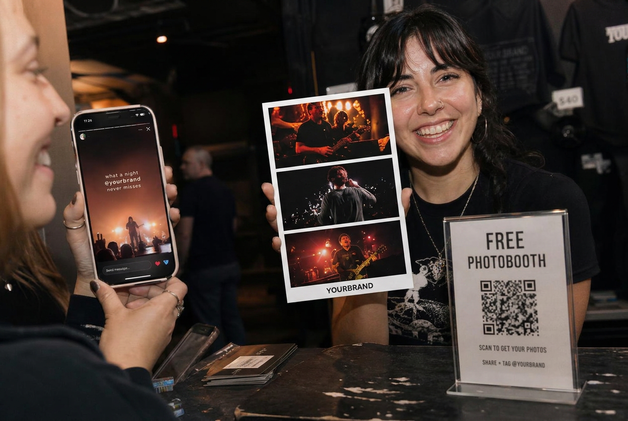 Two fans by the merch desk with a tour photo card and a phone showing the clip from the show