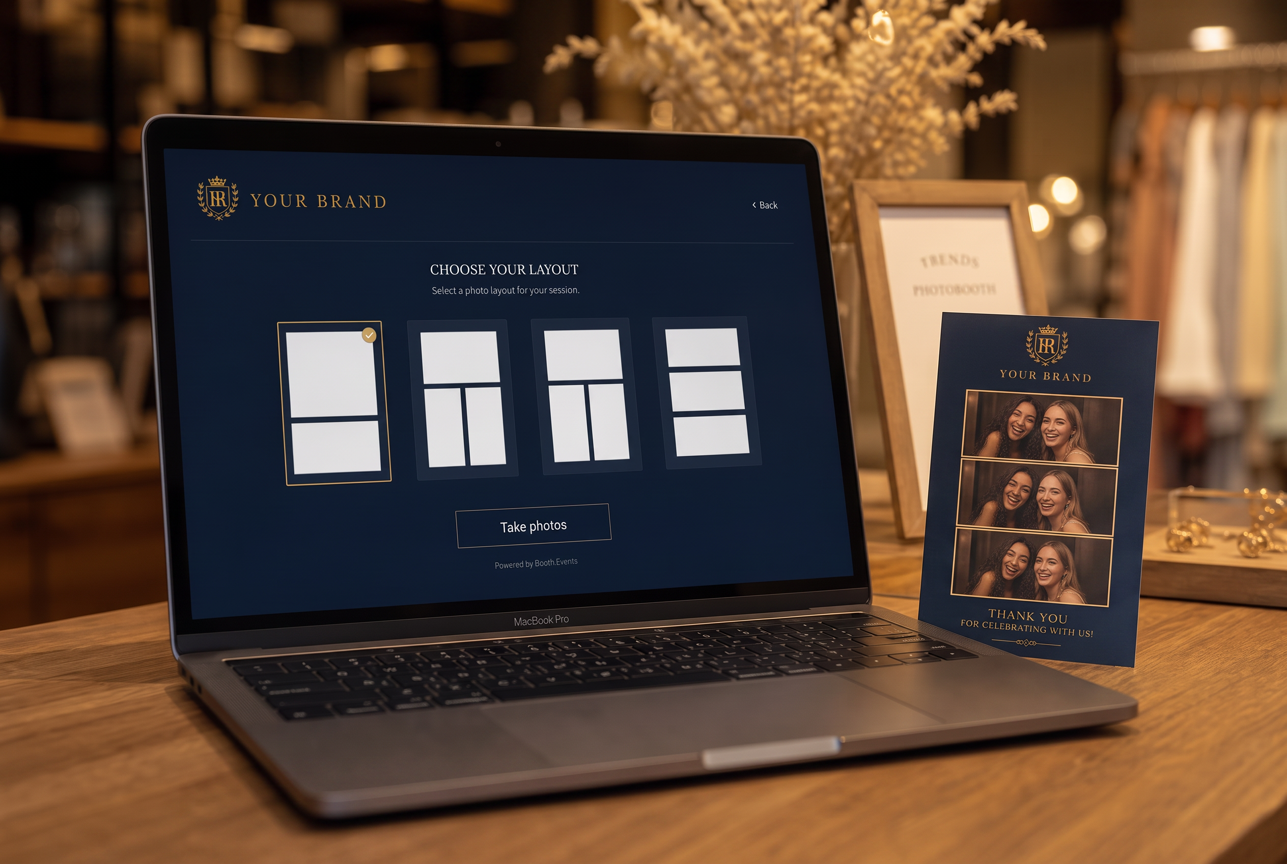 A laptop showing the dark branded capture flow next to a matching printed photo card